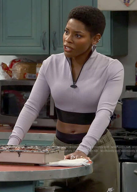 Necie's grey zip neck crop top and green cargo pants on The Neighborhood