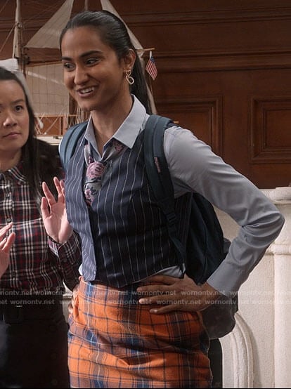 Bela's pinstripe vest and orange plaid skirt on The Sex Lives of College Girls