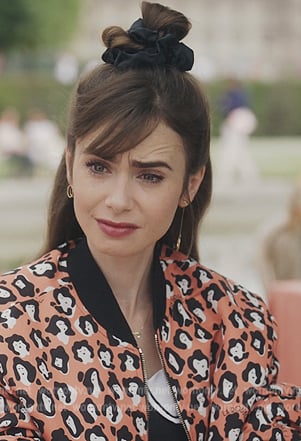 Emily's orange printed bomber jacket on Emily in Paris