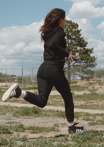 Jess's black stripe sneakers on National Treasure: Edge of History