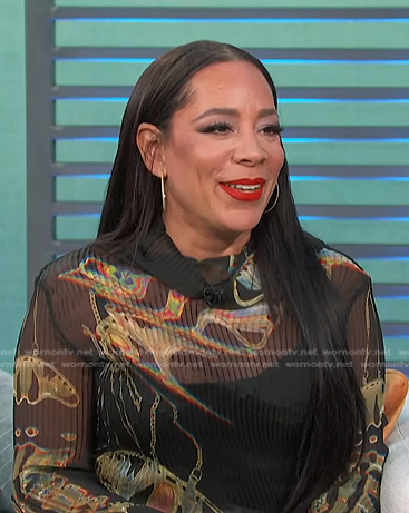 Selenis Leyva's black printed top and check pants on Access Hollywood