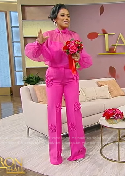 Tamron's pink mesh blouse with floral pants on Tamron Hall Show