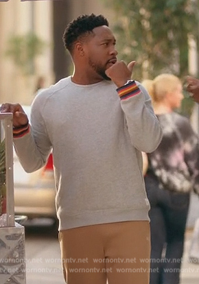 Anthony's gray sweater with stripe cuffs on Grand Crew