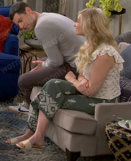 Gemma's white eyelet top and green pants on The Neighborhood
