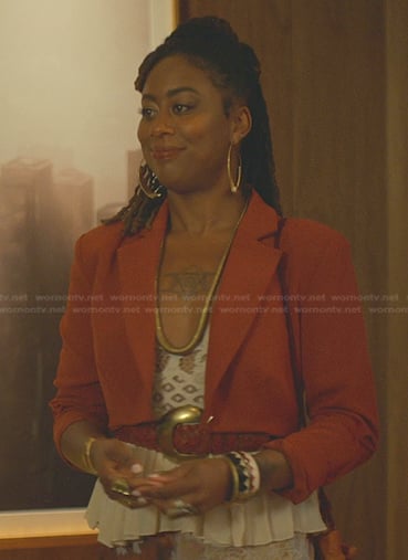 Malika's white peplum top and orange cropped blazer on Good Trouble