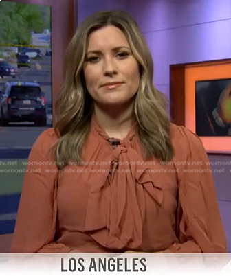 Erin McLaughlin's orange tie neck blouse on Today