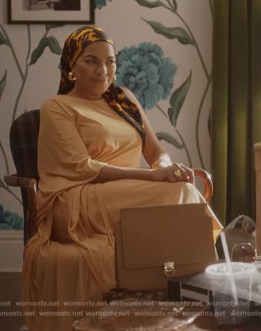 Seema's beige leather handbag and face mask on And Just Like That