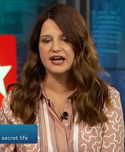 Jenifer Faison's beige contrast print shirt on Access Hollywood