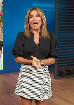Kit's black puff sleeve top and tweed mini skirt on Access Hollywood