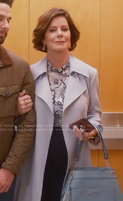 Margaret's light blue coat and floral top on So Help Me Todd