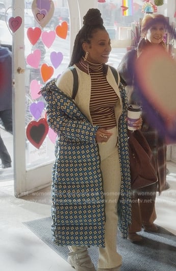 Nya's blue printed puffer coat and bomber jacket on And Just Like That