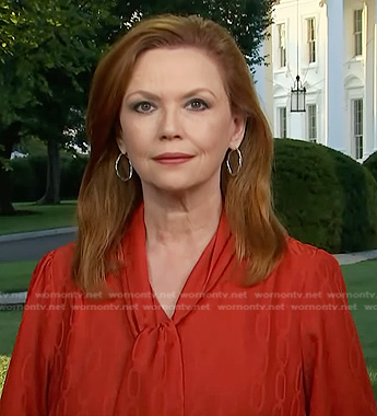 Kelly O’Donnell's red chain print tie neck blouse on Today