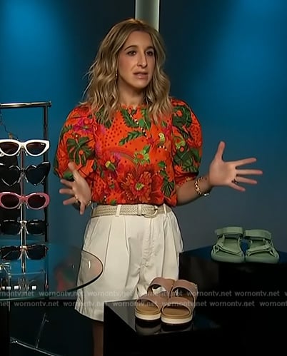 Andrea Lavinthal's red floral print top and hat on Access Hollywood
