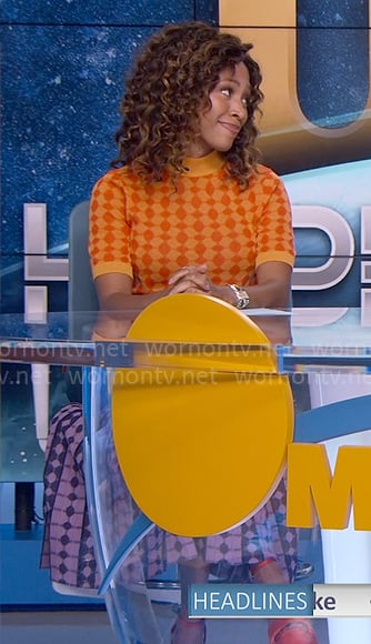 Christina's orange patterned sweater and purple geometric skirt on The Morning Show