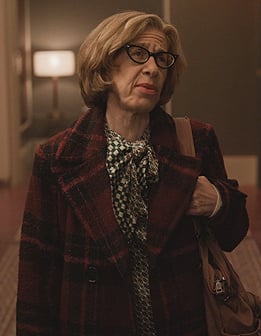 Uma's red plaid coat on Only Murders in the Building
