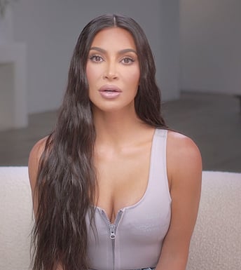 Kim's gray zip front confessional top on The Kardashians