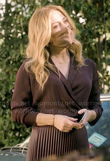 Salma's burgundy wrap blouse and pleated leather skirt on The Morning Show