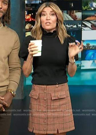 Kit's black puff sleeve top and plaid skirt on Access Hollywood