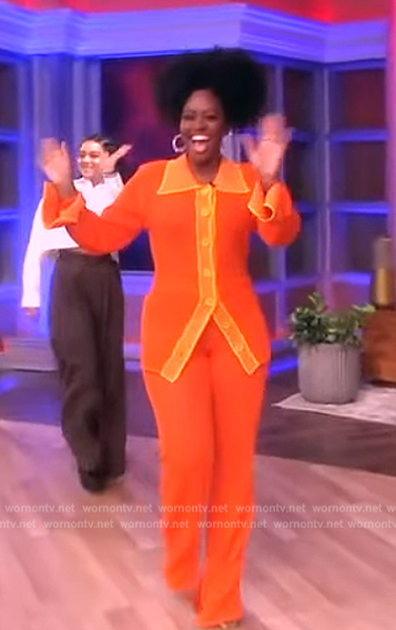 Teyonah Paris' orange open knit top and pants on The View