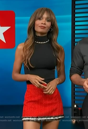 Zuri's black pearl embellished top and tweed mini skirt on Access Hollywood
