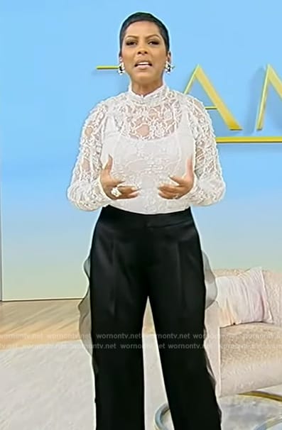Tamron's white lace top and black pants on Tamron Hall Show