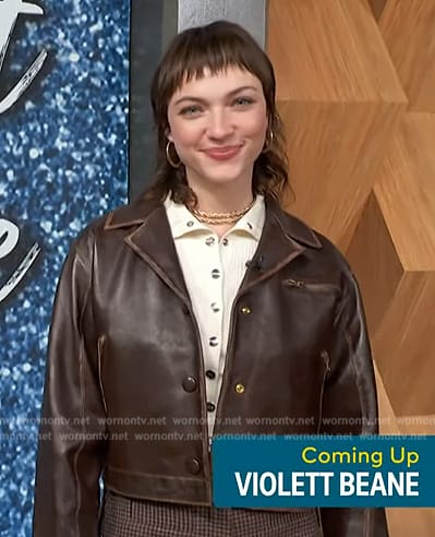 Violett Beane's brown leather jacket and ribbed top on Access Hollywood