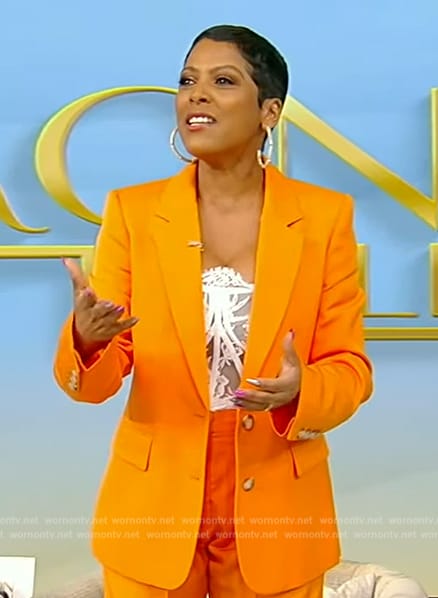 Tamron's white lace bustier top and blazer on Tamron Hall Show