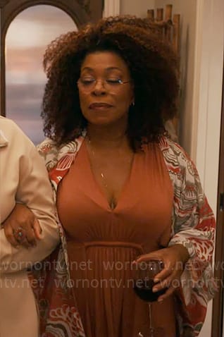 Vi's orange v-neck dress and printed jacket on The Equalizer