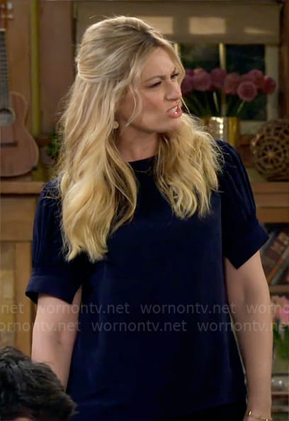 Gemma's navy puff-sleeve top on The Neighborhood