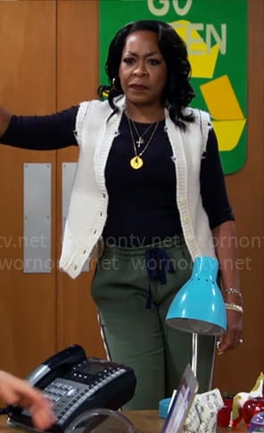 Tina's white sweater vest and green side stripe pants on The Neighborhood