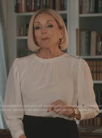 Joann's beige coat and white top on Elsbeth