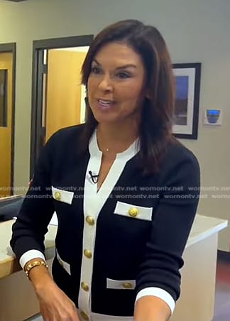 Meg Oliver's black contrast trim cardigan on CBS Evening News