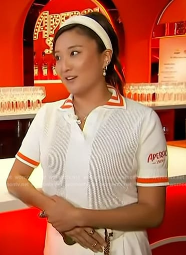 Ashley Park's white and orange cropped polo on Access Hollywood