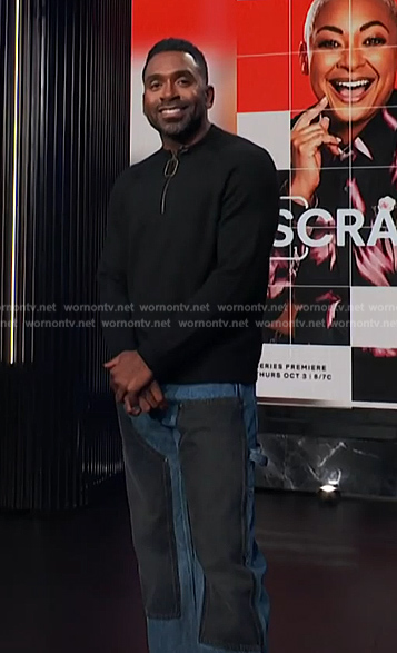 Justin's zip sweater and denim jeans on E! News