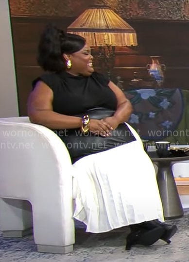 Danielle Pinnock's black draped top and leahter detail skirt on CBS Mornings