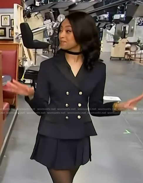 Colby Muhammad's navy blazer and mini skirt on Access Hollywood