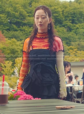 Yuri's multicolor tie dye top and black rosette dress on XO Kitty