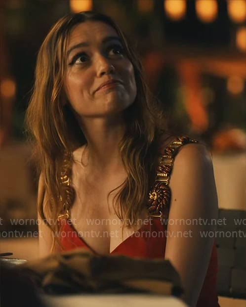 Chelsea's red dress with gold and wood straps on The White Lotus