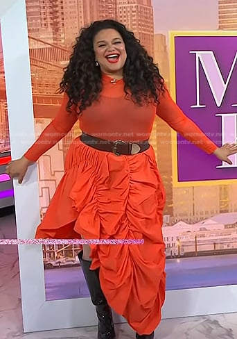 Michelle Buteau's orange mesh top and asymmetric skirt on Today