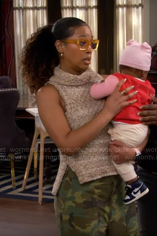 Courtney's beige knit turtleneck top on The Neighborhood