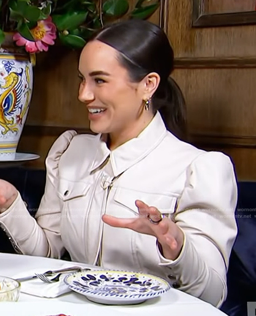 Emily Curl's white leather puff sleeve jacket on E! News