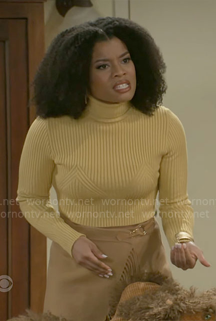 Eva's yellow sweater and fringed wrap skirt on Beyond the Gates