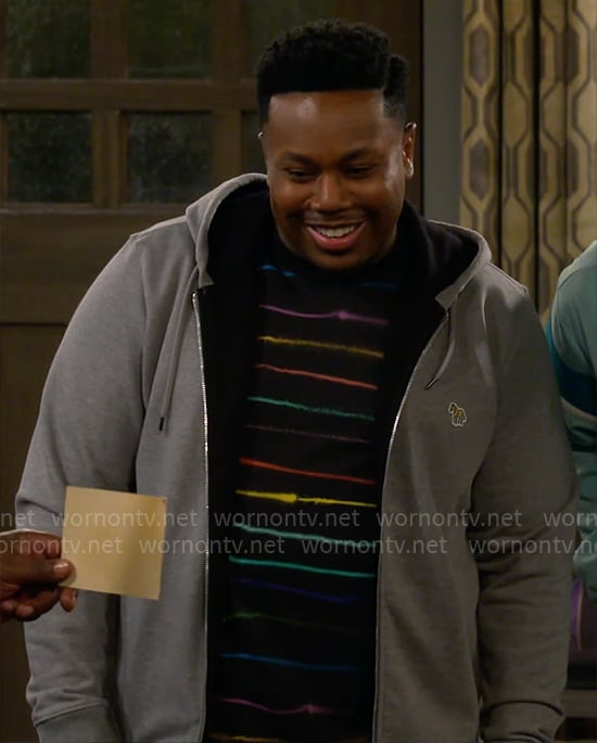 Marty's rainbow striped t-shirt and grey hoodie on The Neighborhood