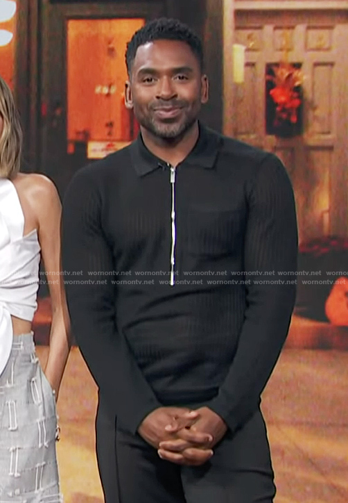 Justin's black half zip sweater on E! News