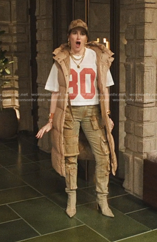 Maya's beige puffer long vest and jeans on The Studio