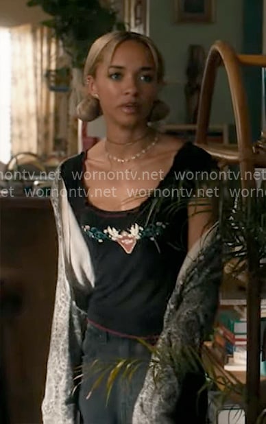 Ava's black heart graphic top on High Potential