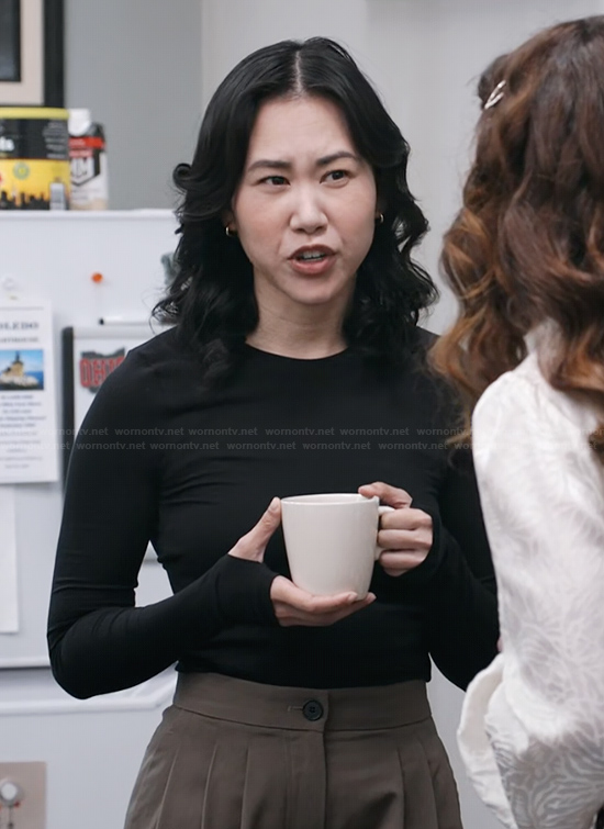Nicole's black long sleeve top on The Paper