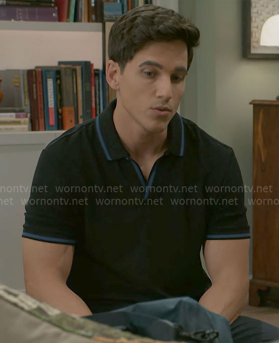 Smitty's black polo shirt with blue trims on Beyond the Gates