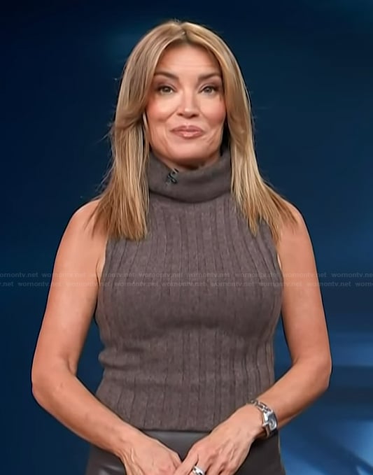 Kit's brown turtleneck ribbed tank and leather skirt on Access Hollywood