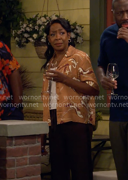 Tina's orange floral shirt on The Neighborhood